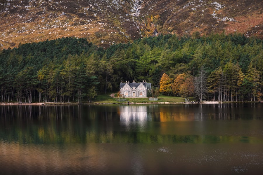 A stone lodge reflected in a Highland loch